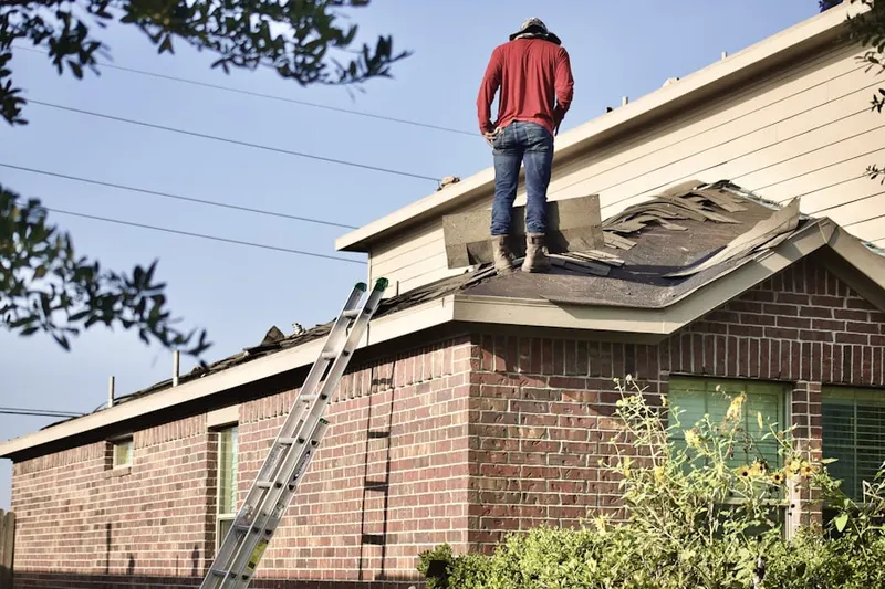 Professional roofer working on a residential roof in East Killingly